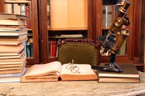 A picture of books and a microscope